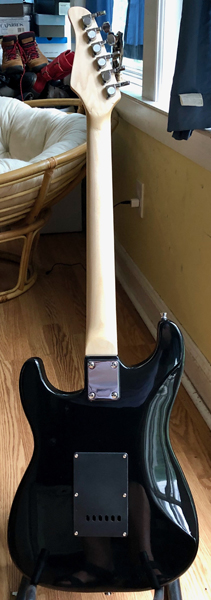 Buddy's back is basic black with a matching tremolo cover. His neck is chunky, "'50s-style," hand-shaped with a tung-oil finish.