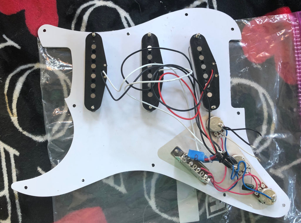 A look inside The Malmsteen's wired pickguard. The Alnico V's sing!